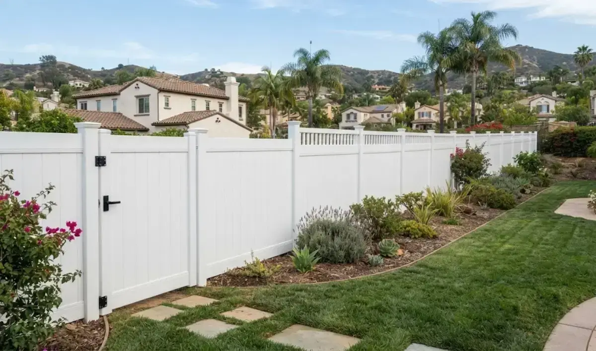 White vinyl privacy fence installation in Glendale, CA backyard showing cost-effective fencing with mountain and landscaping views