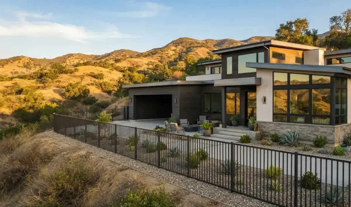 Fire-resistant steel fence along a hillside home in Glendale, CA with drought-tolerant landscaping